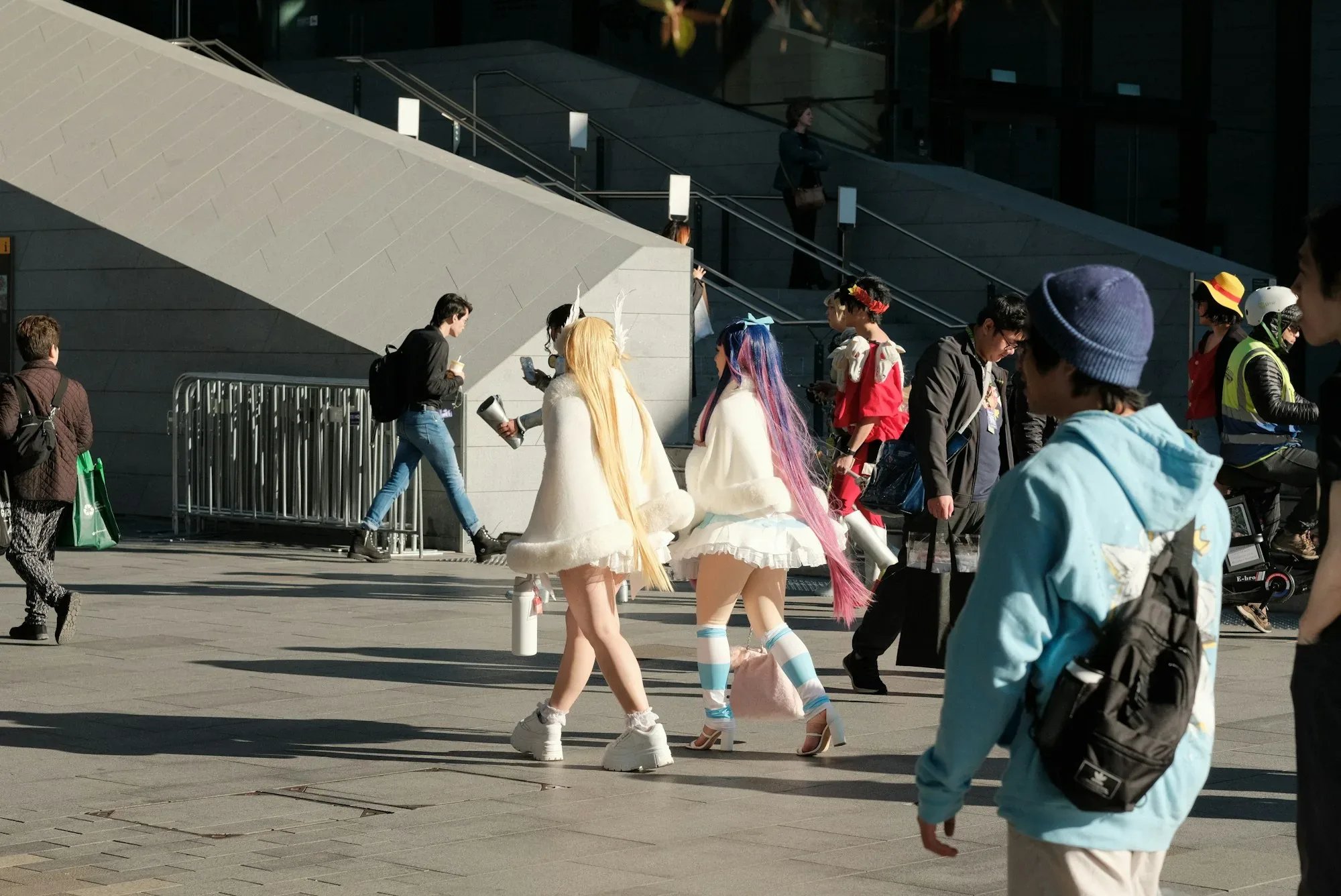 Cosplayers walking through a convention district.